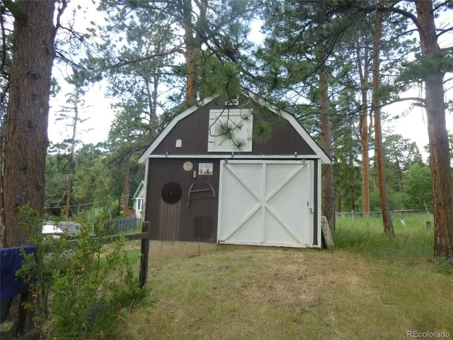 a view of a chair and table in backyard of the house