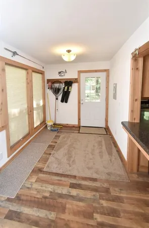 a view of a livingroom with wooden floor and a large window