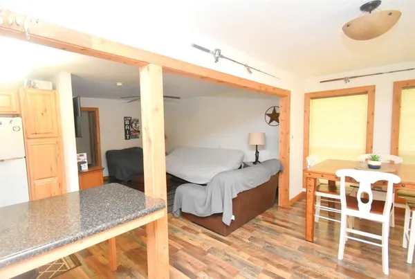 a en suite bathroom with a granite countertop double vanity sink and mirror