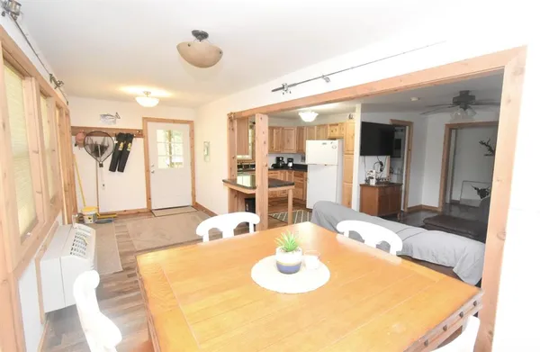 a living room with dining table and wooden floor