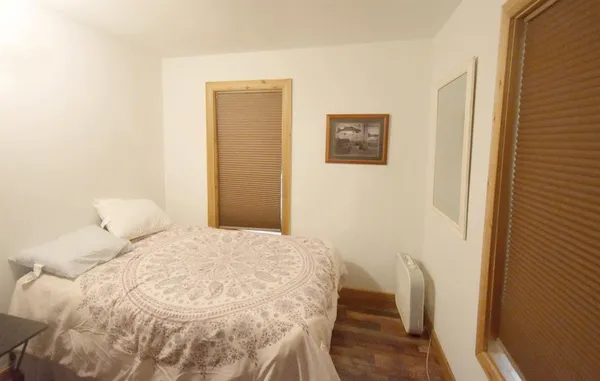 a bedroom with a bed and a table