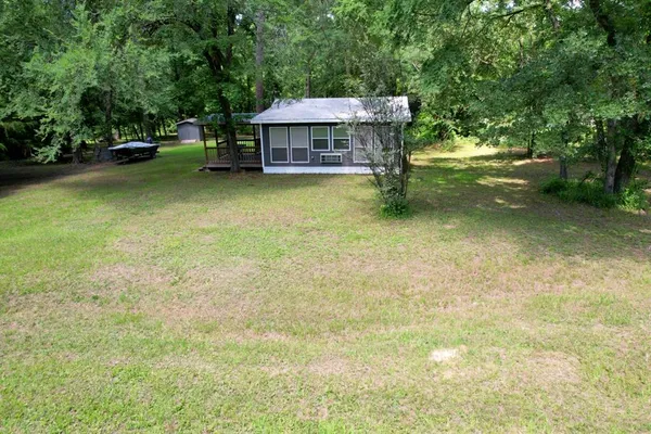 a view of a house with a yard and sitting area