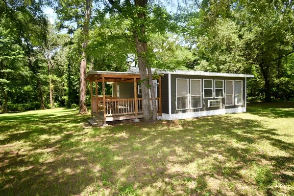 a view of a house with backyard outdoor seating and yard
