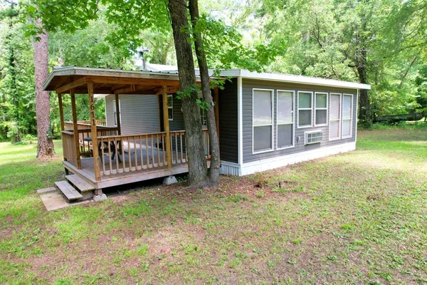 a view of a house with a yard and deck