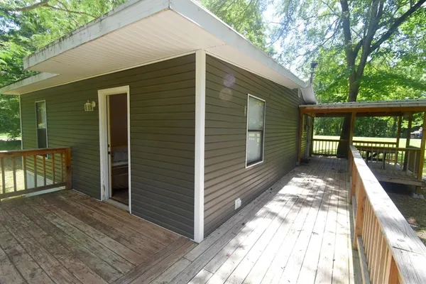 a view of a balcony with wooden floor and fence