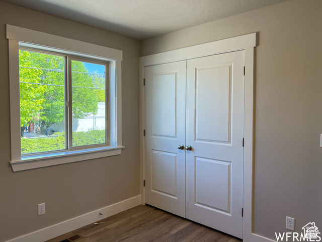 702 North 100 West Logan, UT 84321 - Photo 31 of 58 Unfurnished bedroom featuring a closet, baseboards, and wood finished floors