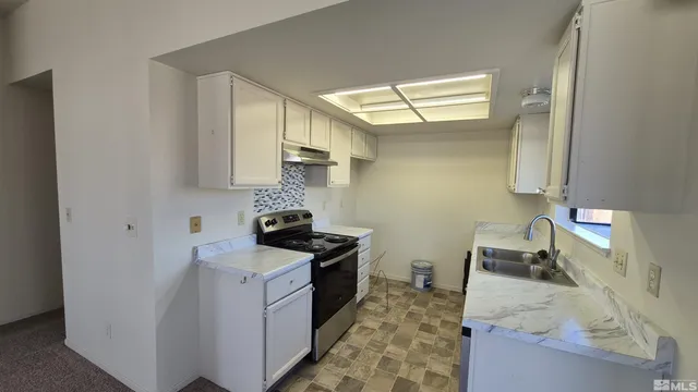 a kitchen with a stove and a sink