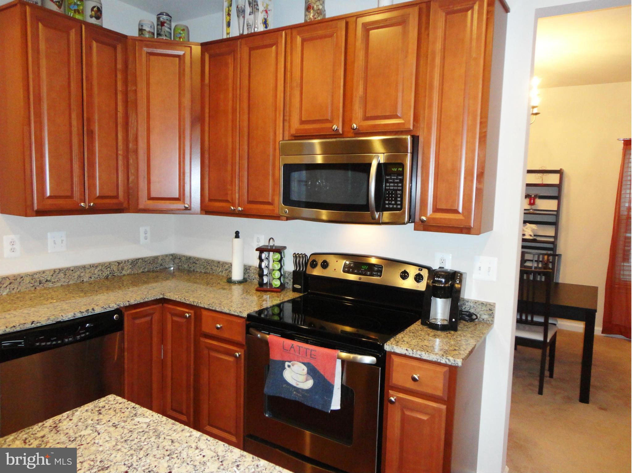 14302 Lusby Ridge Road Accokeek, MD 20607 - Photo 16 of 30 Kitchen Stove & Microwave & Cabinets