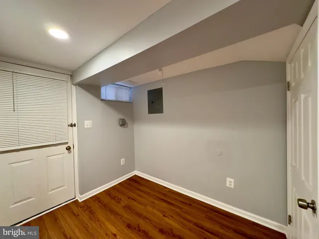 a view of a room with wooden floor