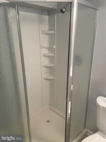 a bathroom with a glass shower door