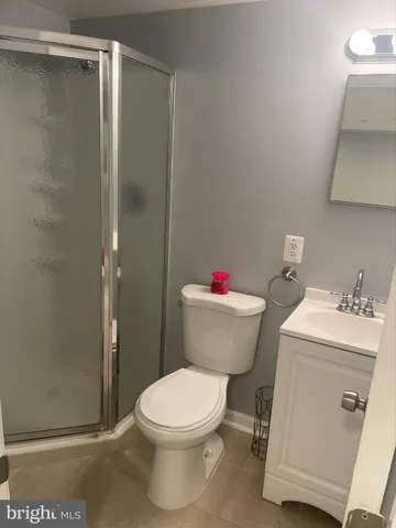 a white toilet sitting next to a bathroom sink