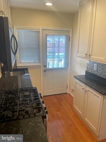 a kitchen with granite countertop a stove and a sink