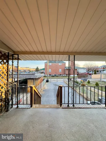 a view of a patio with table and chairs