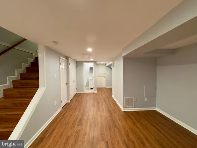 a view of a room with wooden floors and staircase