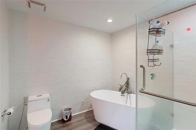 a white bath tub sitting next to a white toilet