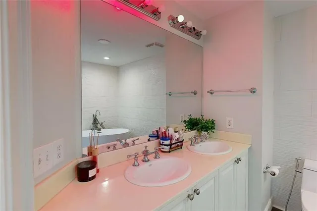 a bathroom with a sink double vanity and a tub