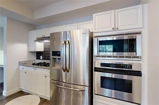 a kitchen with a sink stove and cabinets