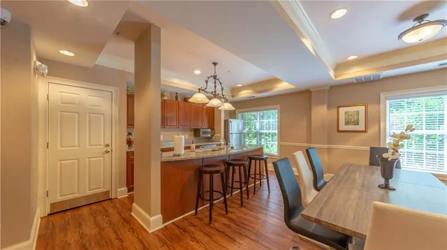 a living room with furniture a large window and wooden floor