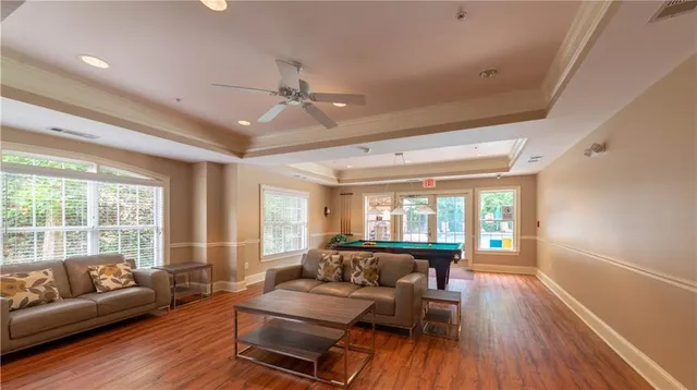 a room with pool table and windows