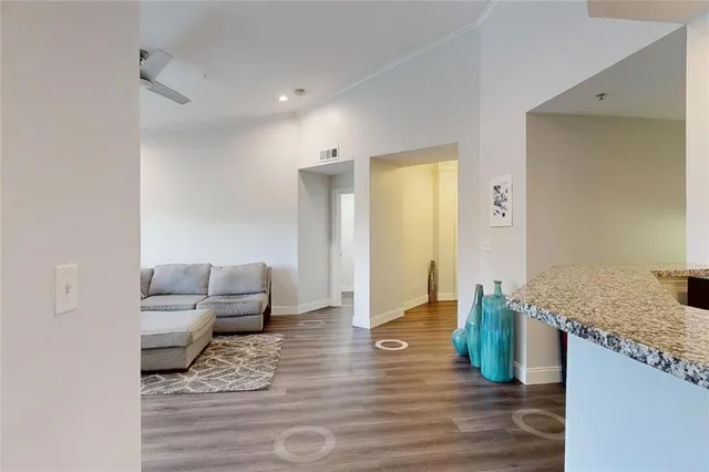 a living room with furniture and a wooden floor