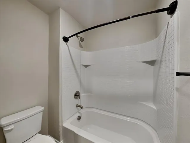 a bathroom with a shower and a toilet