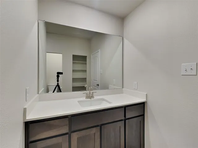 a bathroom with a sink and a mirror