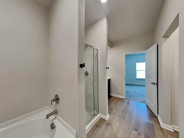 a view of a room with wooden floor