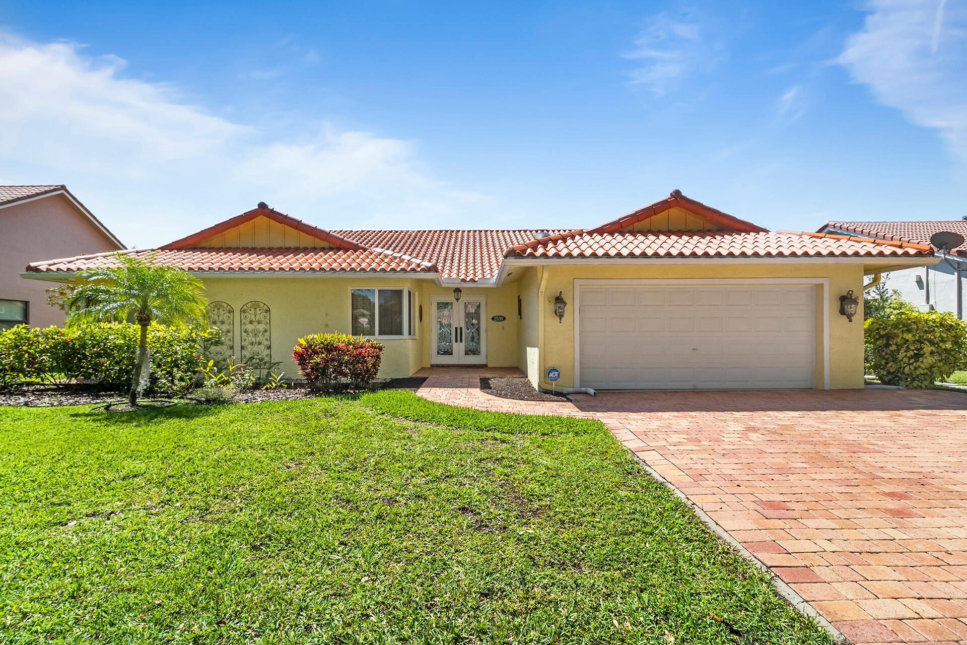 2530 Northwest 40th Street Boca Raton, FL 33434 - Photo 1 of 35 a front view of a house with a garden and porch