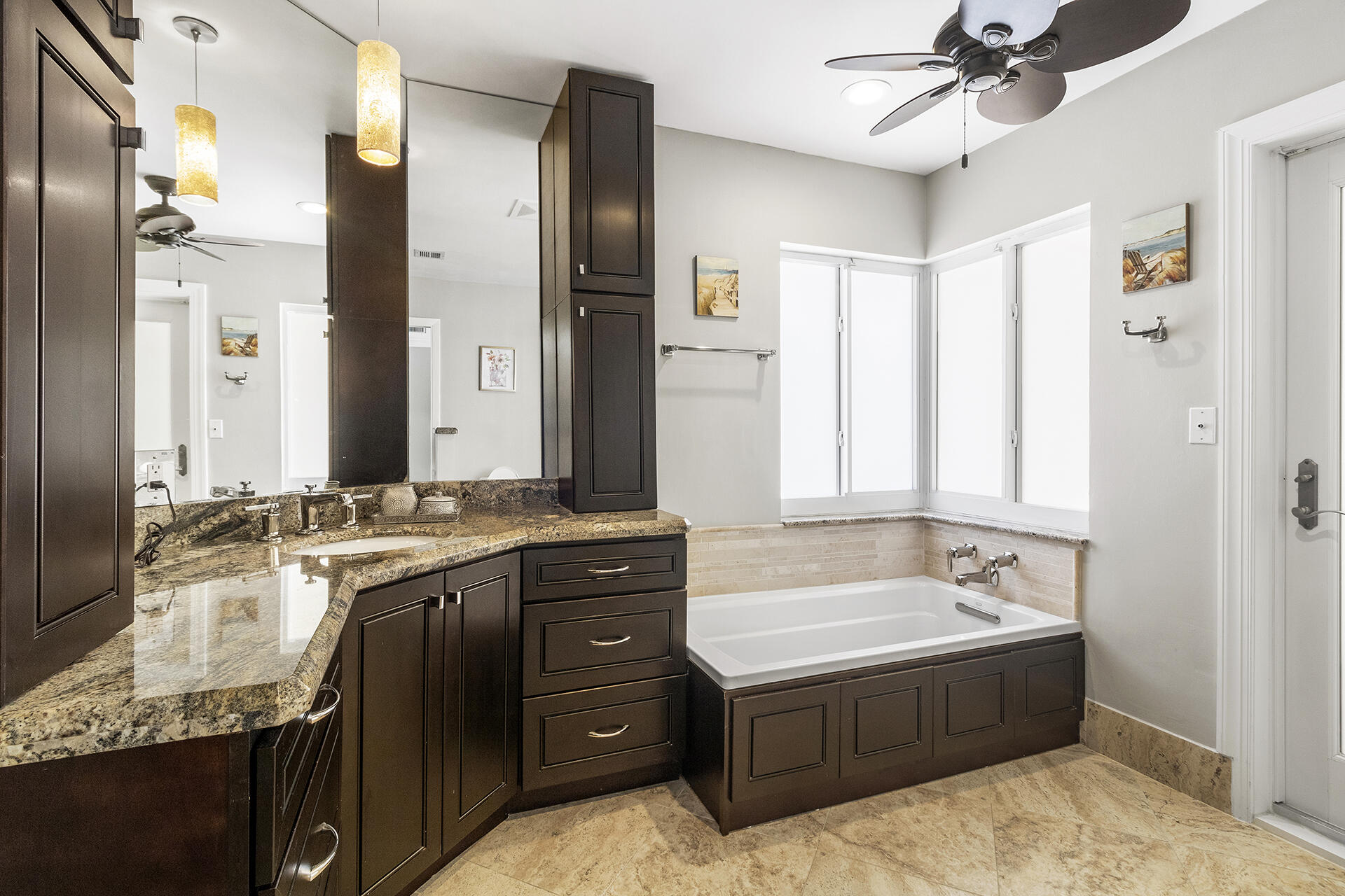 2530 Northwest 40th Street Boca Raton, FL 33434 - Photo 11 of 35 a spacious bathroom with a granite countertop tub sink and mirror