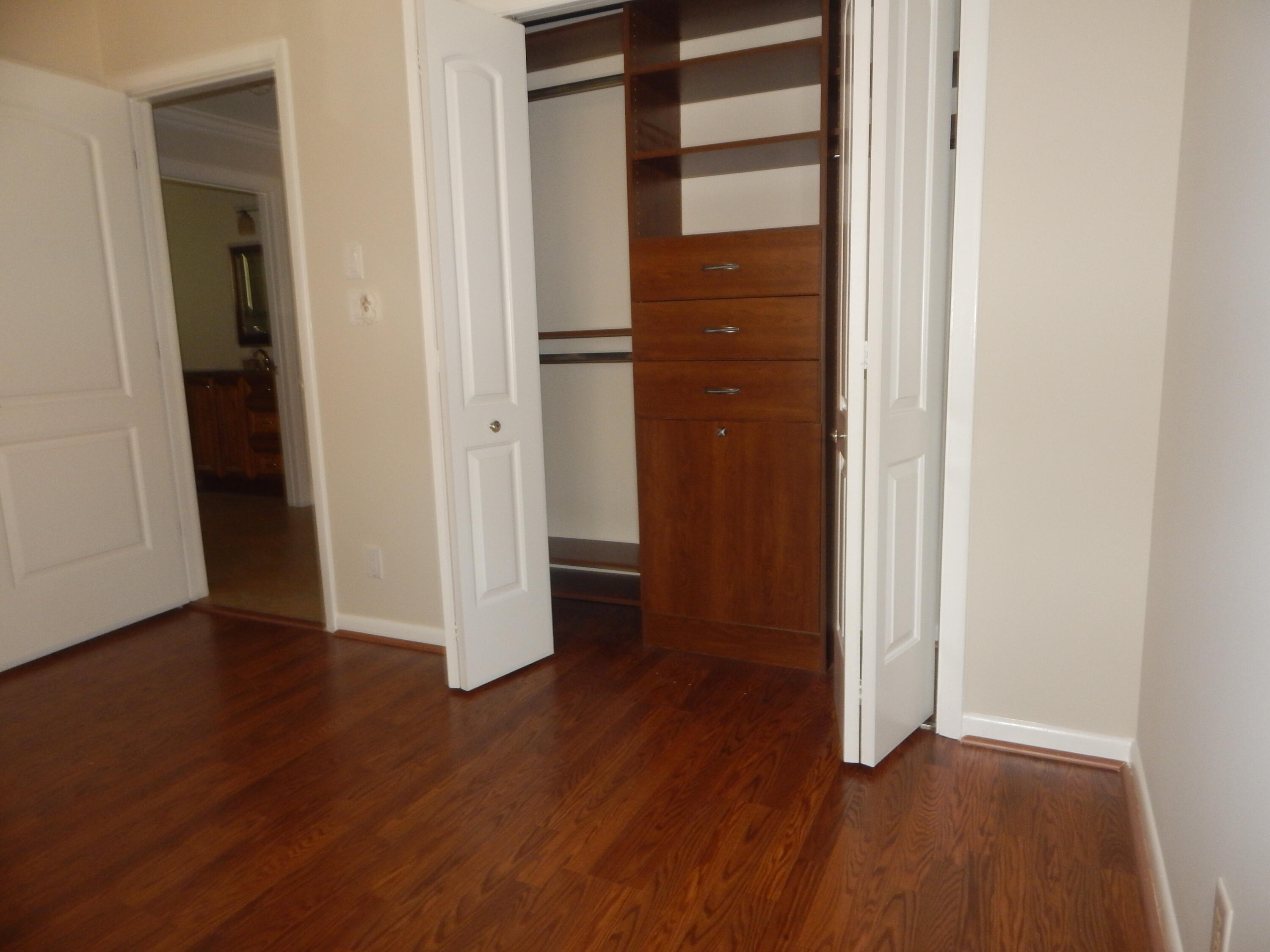 2530 Northwest 40th Street Boca Raton, FL 33434 - Photo 16 of 35 an empty room with wooden floor & closet