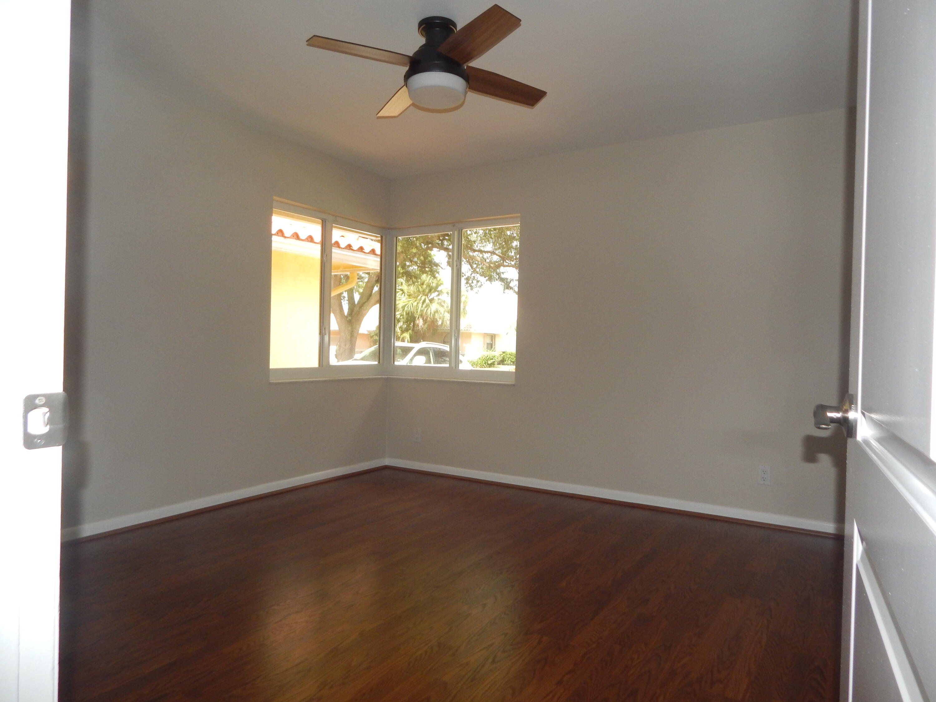 2530 Northwest 40th Street Boca Raton, FL 33434 - Photo 17 of 35 a view of empty room with wooden floor and fan