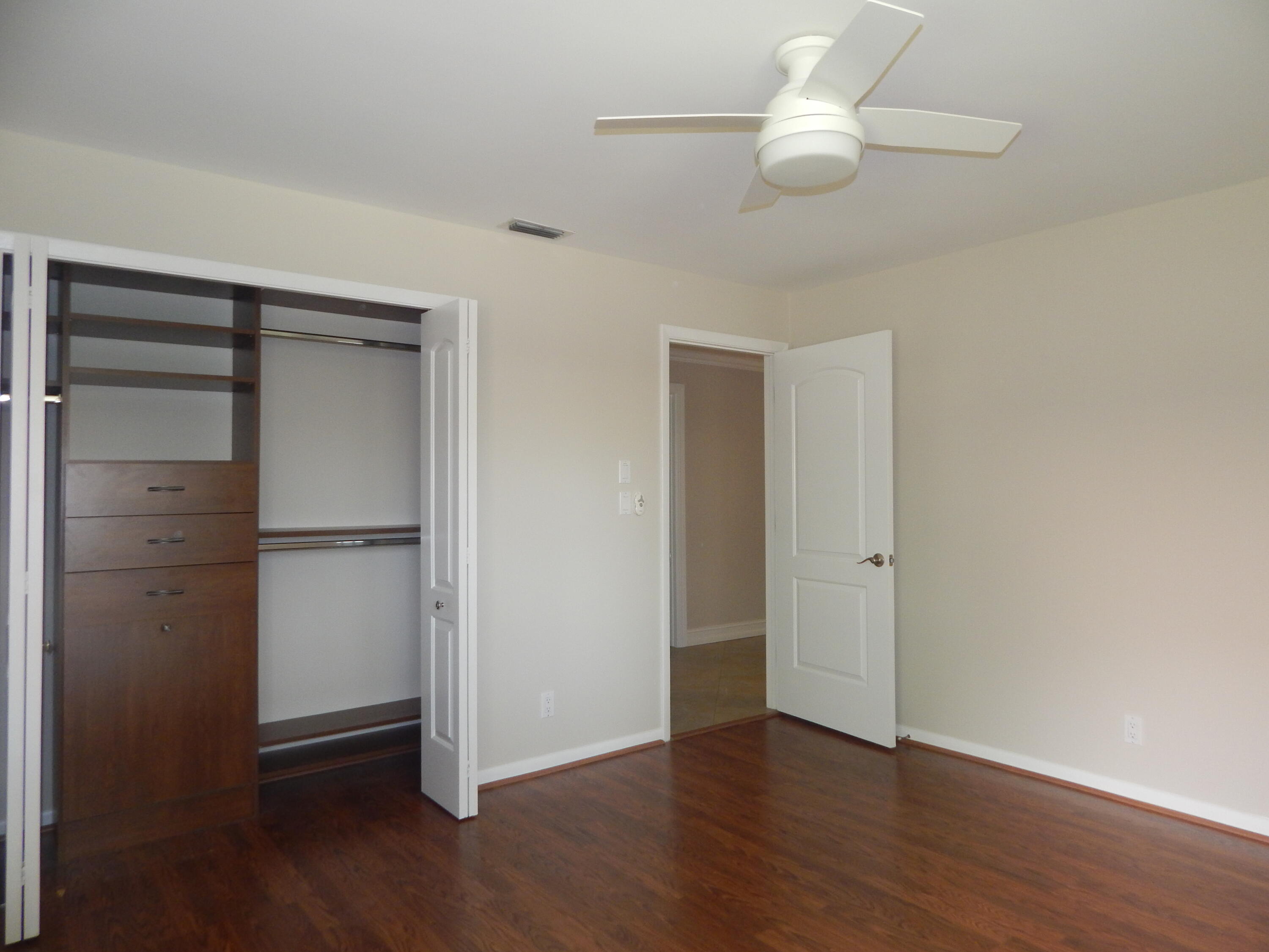 2530 Northwest 40th Street Boca Raton, FL 33434 - Photo 19 of 35 a view of an empty room with wooden floor