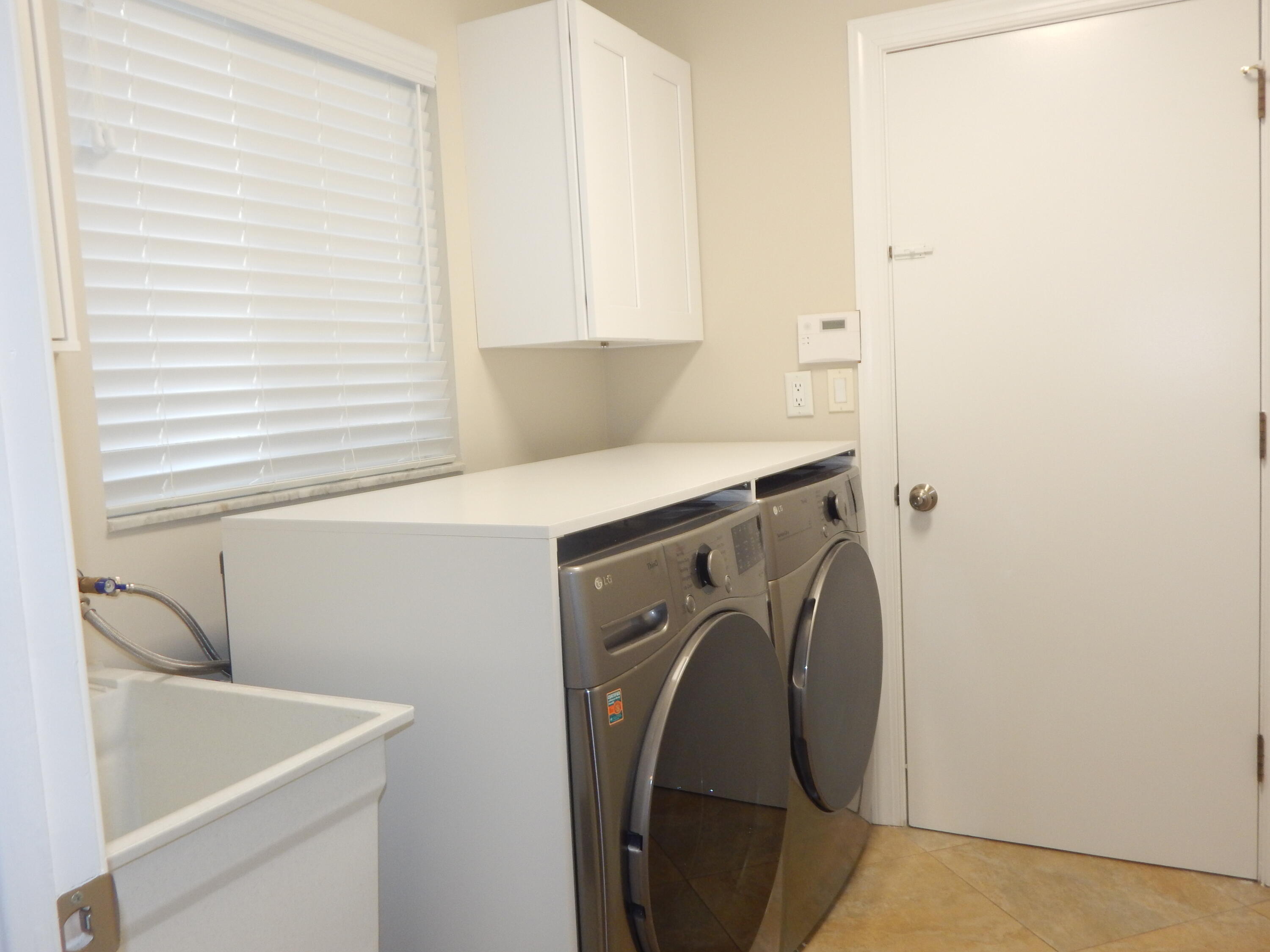 2530 Northwest 40th Street Boca Raton, FL 33434 - Photo 24 of 35 a utility room with dryer and washer