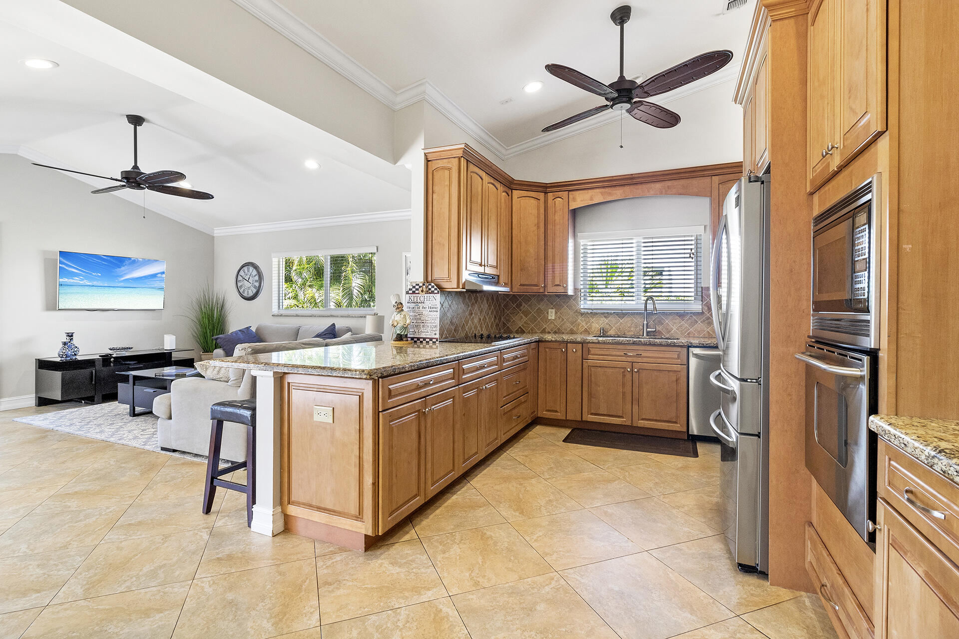2530 Northwest 40th Street Boca Raton, FL 33434 - Photo 4 of 35 a kitchen with stainless steel appliances granite countertop a sink and a refrigerator