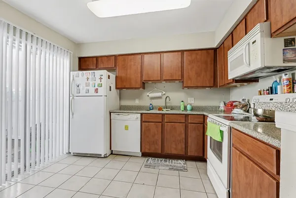 a kitchen with a refrigerator sink and cabinets