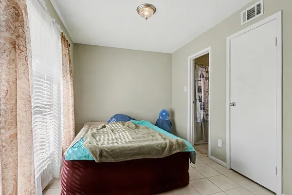 a bedroom with a bed and a window