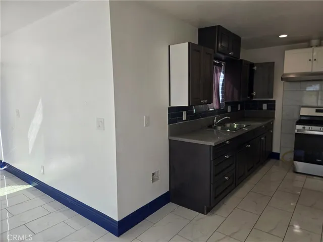a kitchen with a refrigerator and a stove