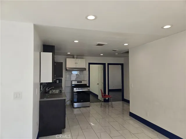 a kitchen with stainless steel appliances a refrigerator and a stove top oven