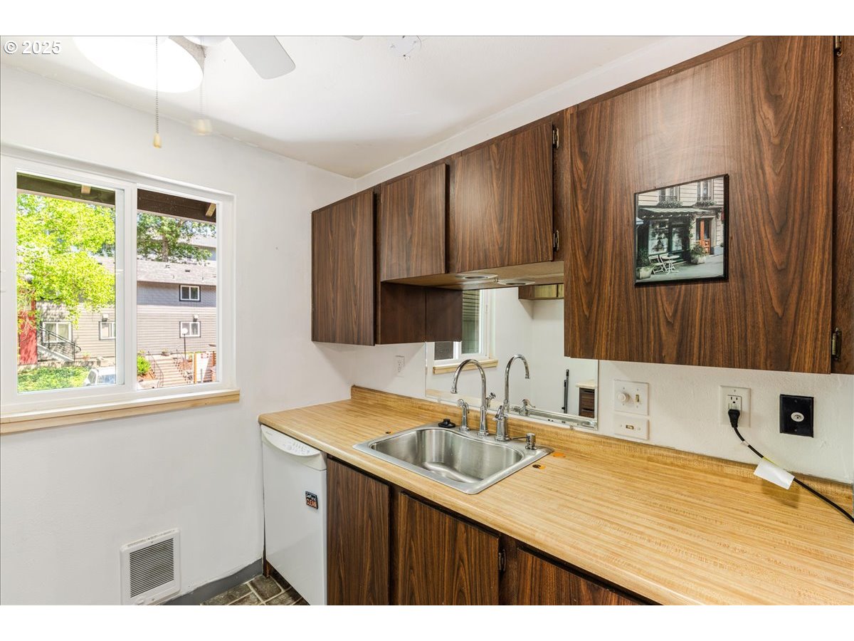 12620 Northwest Barnes Road, Unit 5 Portland, OR 97229 - Photo 13 of 26 a kitchen with a sink cabinets and window