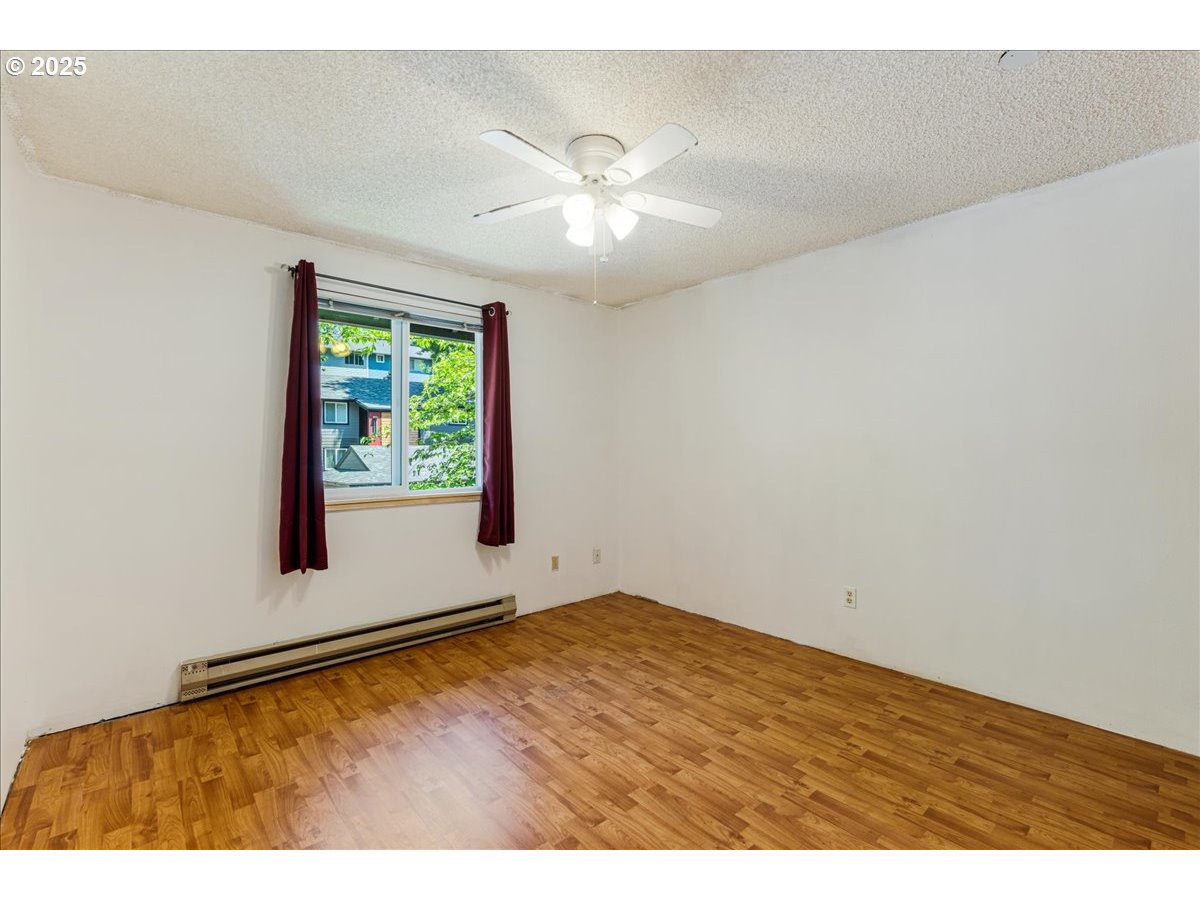 12620 Northwest Barnes Road, Unit 5 Portland, OR 97229 - Photo 14 of 26 a view of an empty room with window and wooden floor
