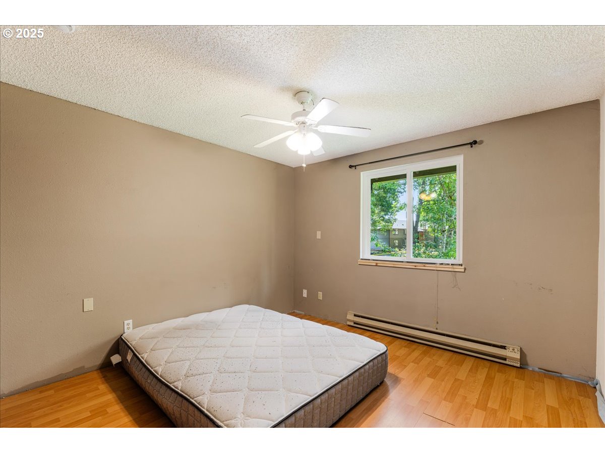 12620 Northwest Barnes Road, Unit 5 Portland, OR 97229 - Photo 16 of 26 an empty room with a ceiling fan and a window