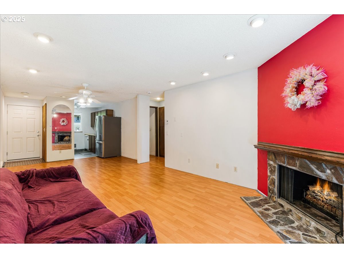 12620 Northwest Barnes Road, Unit 5 Portland, OR 97229 - Photo 7 of 26 a living room with furniture and a fireplace