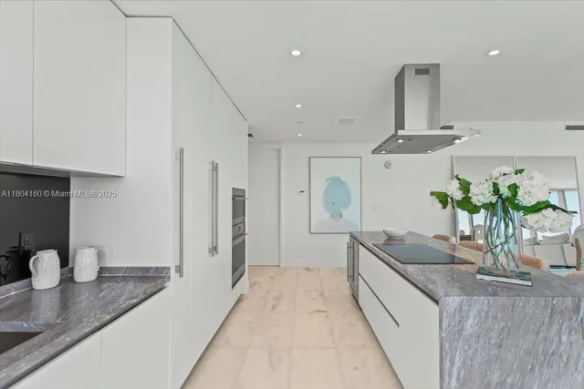 a kitchen with stainless steel appliances granite countertop a sink a stove and a refrigerator