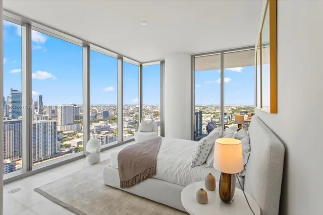 a living room with furniture and a floor to ceiling window