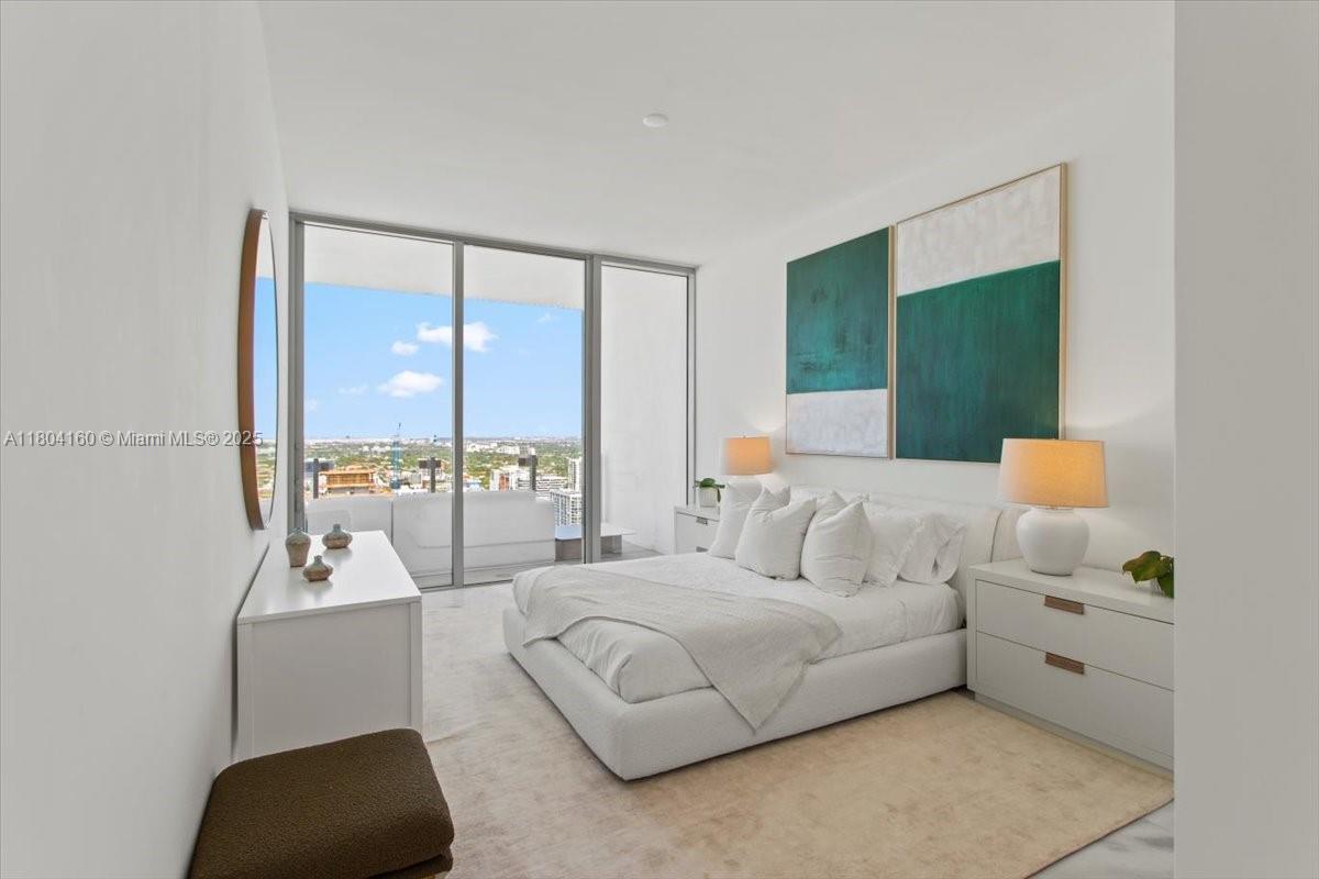 700 Northeast 26th Terrace, Unit 3903 Miami, FL 33137 - Photo 24 of 42 a bedroom with a bed and a large window