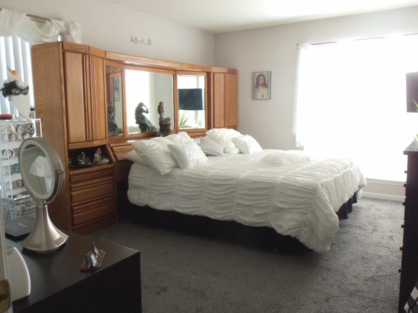 816 Riding Lane St. Charles, IL 60174 - Photo 12 of 20 a bedroom with a bed and dresser with mirror
