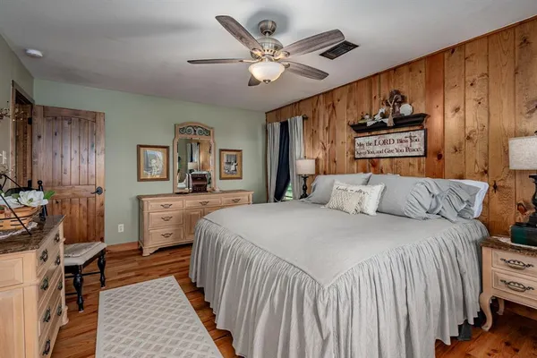 a bed room with a bed and a computer on a dresser