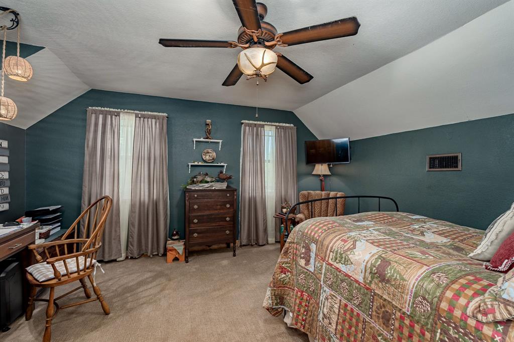 14392 Highway 78 Blue Ridge, TX 75424 - Photo 21 of 40 a bedroom with a bed and a chandelier