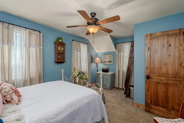 a bedroom with a bed and a chandelier