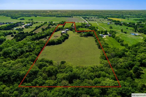an aerial view of a house with a yard